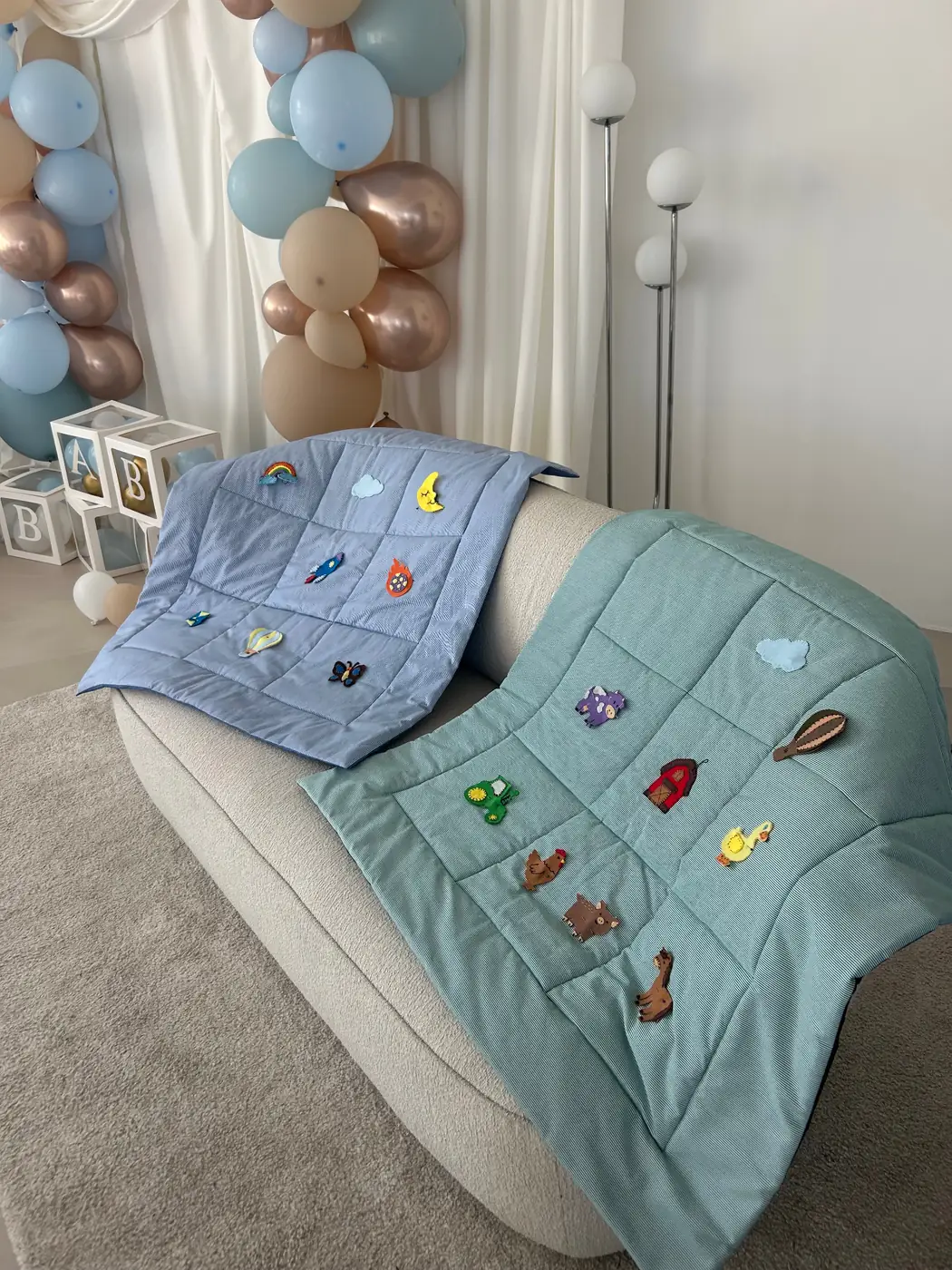 Two finished felt play mats draped over an armchair