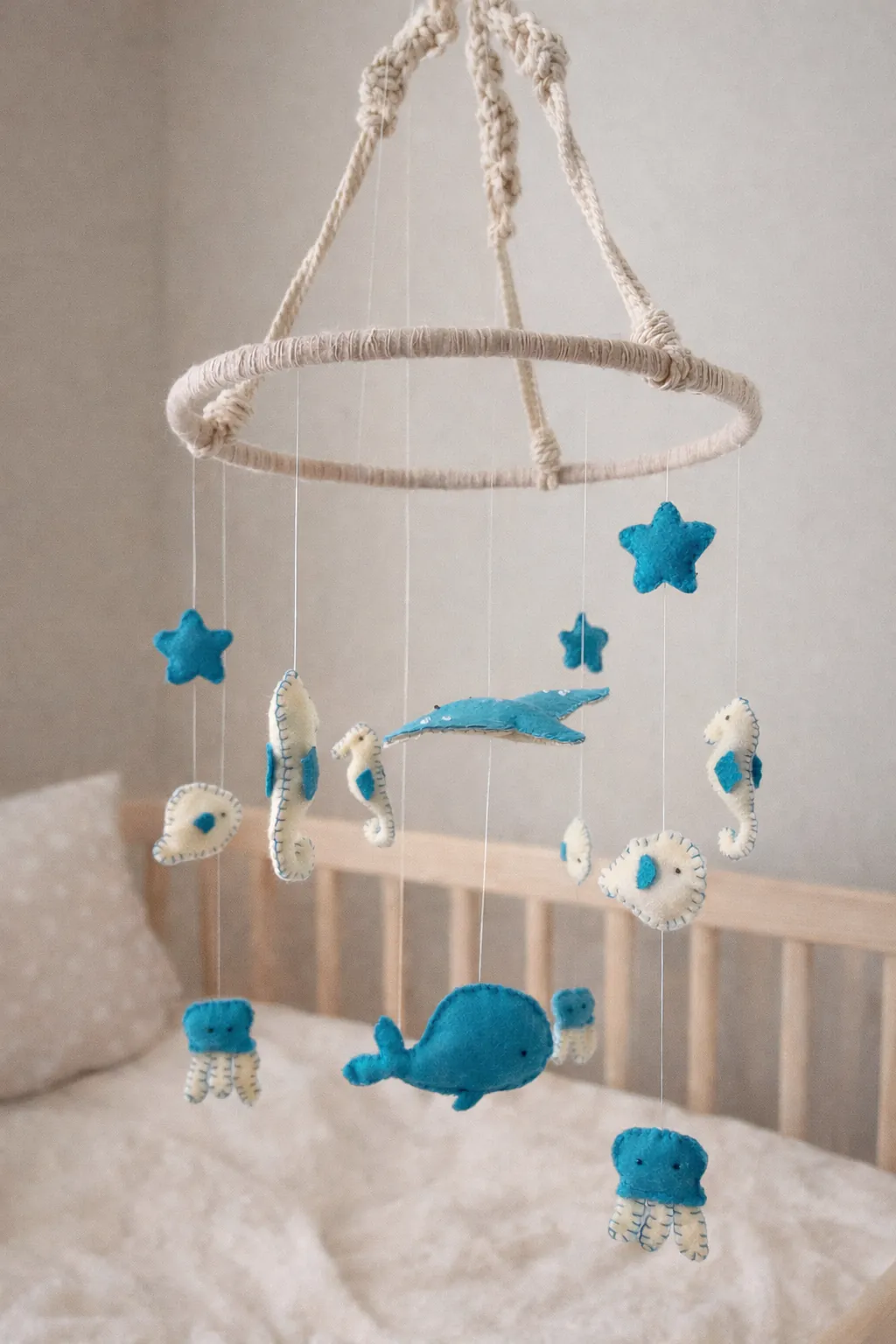 Felt sea-themed baby mobile hanging above a cot