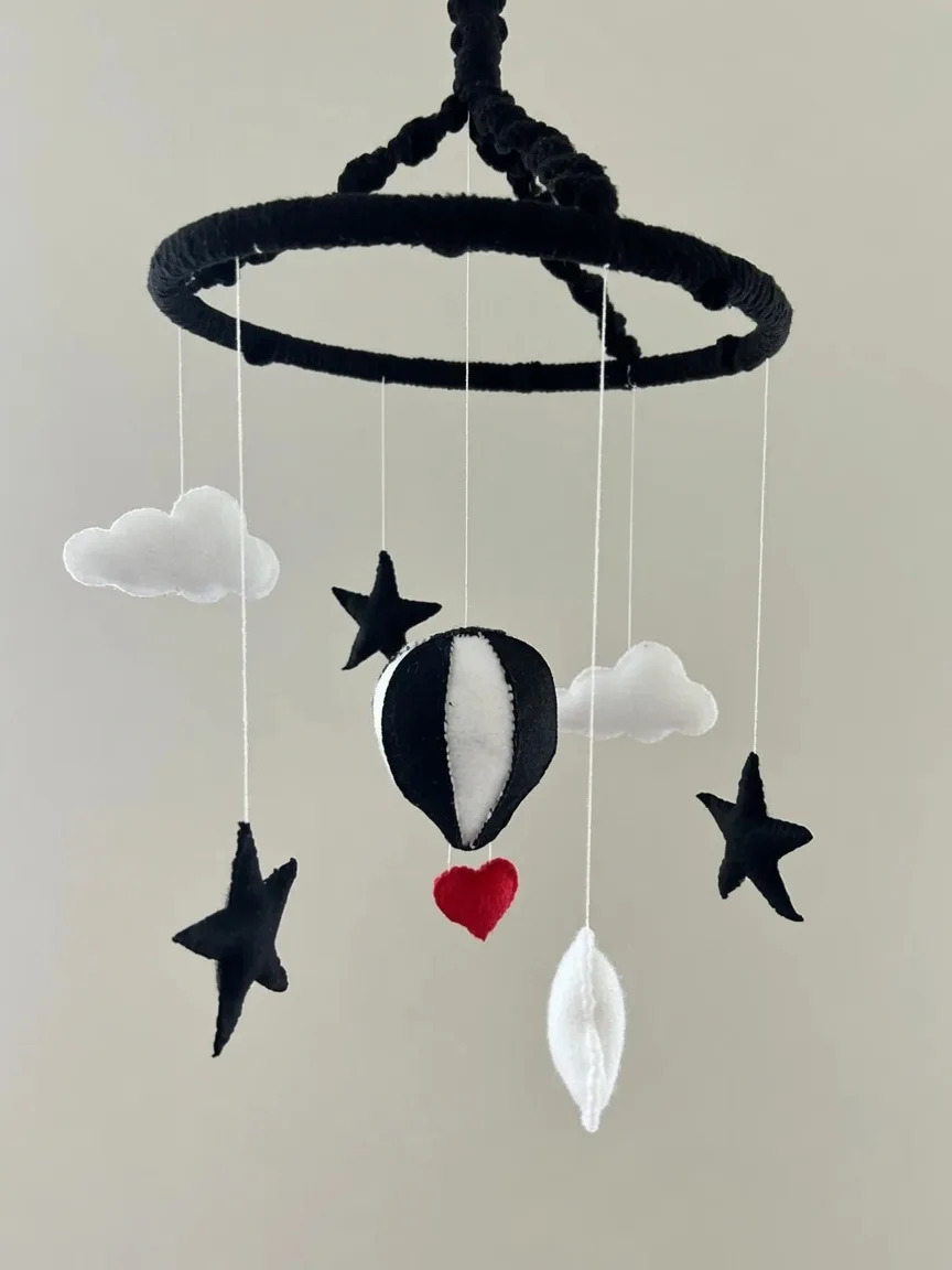 Black and white felt baby mobile with a red heart
